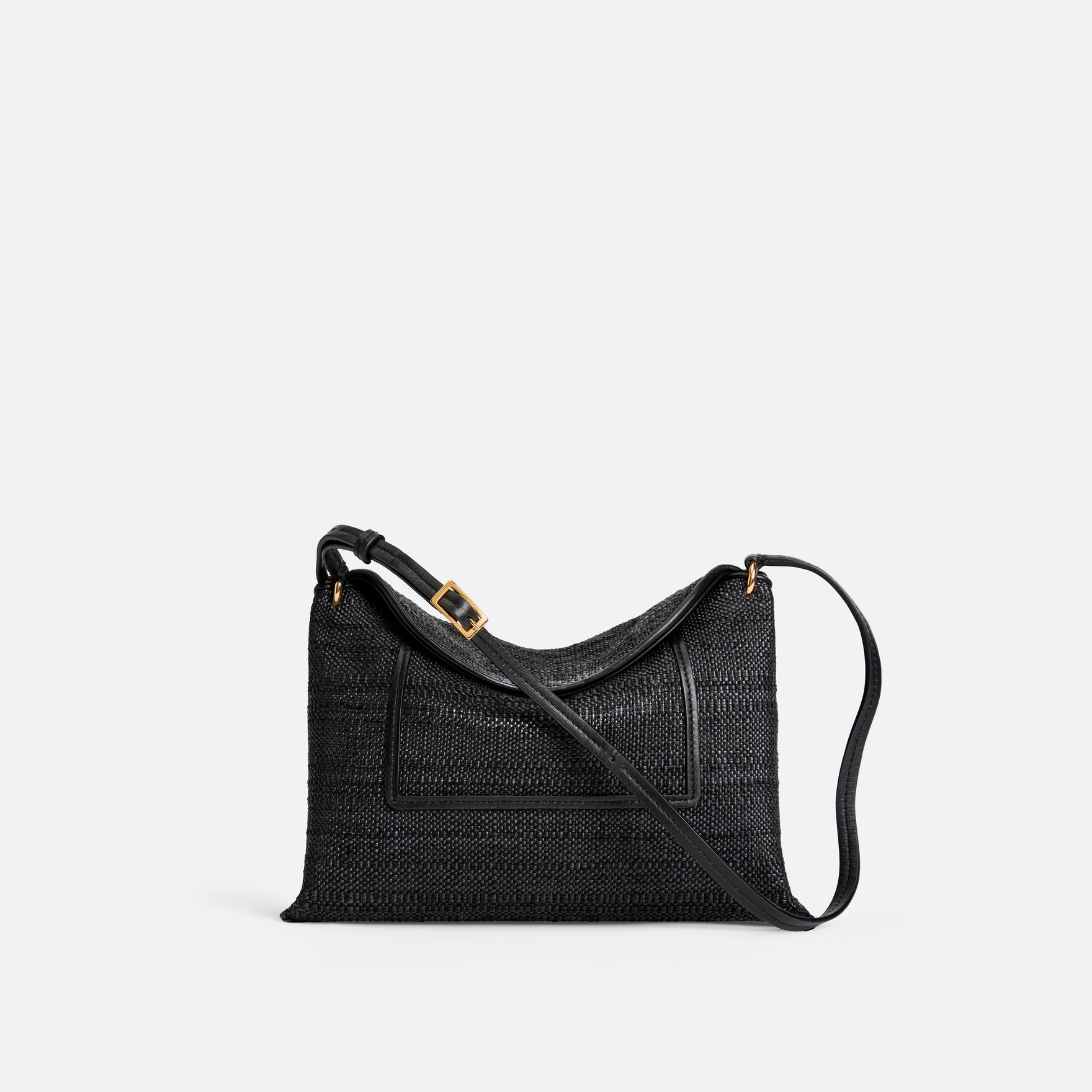 Wandler Penelope Slouch Bag in the color Black Raffia, made from raffia and smooth calf leather with golden hardware and adjustable slim strap, front view.