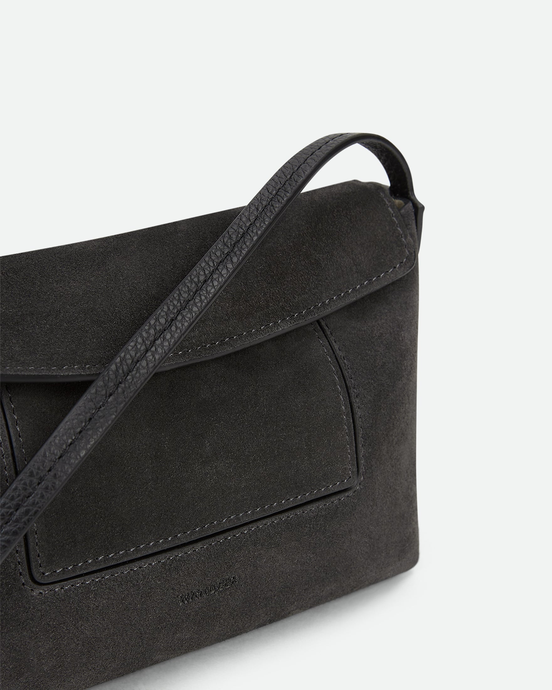 Wandler Penelope Slouch Mini in the color Space Suede, grey, made from Italian calf leather with golden hardware and slim adjustable strap, close up detailing the leather. 