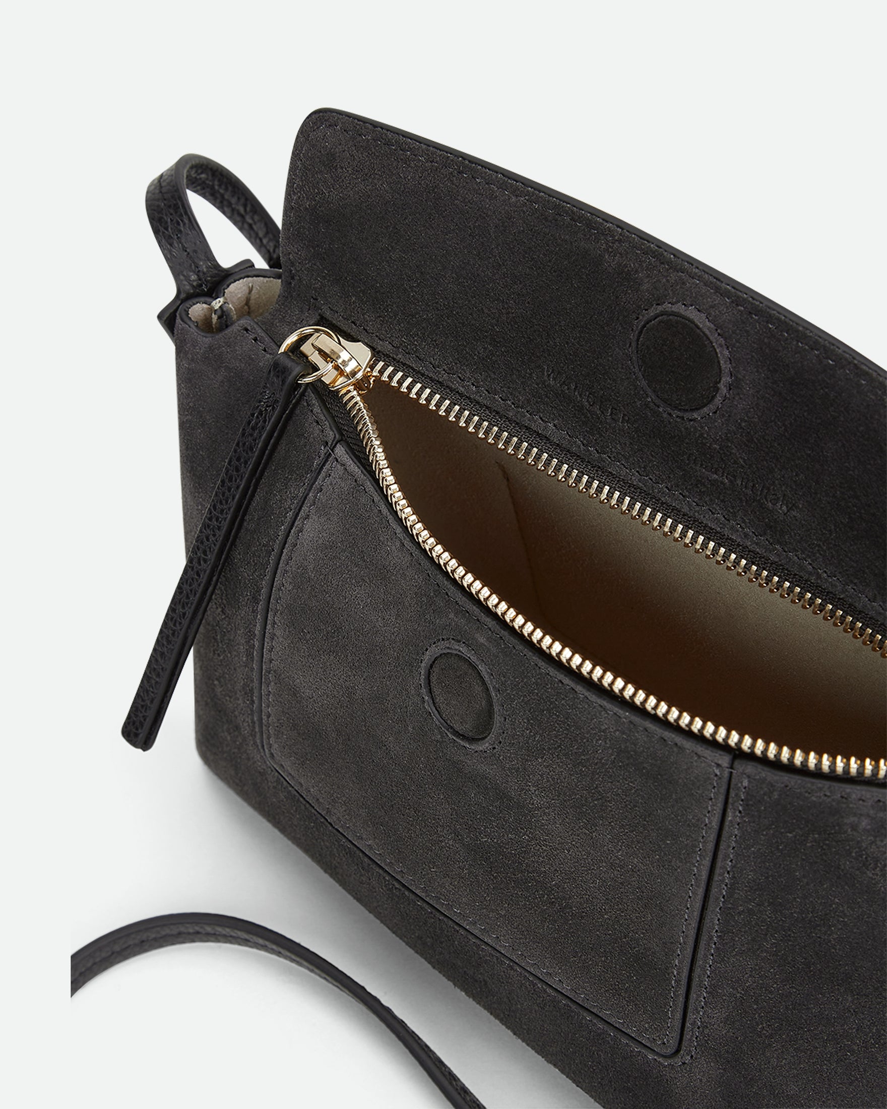 Wandler Penelope Slouch Mini in the color Space Suede, grey, made from Italian calf leather with golden hardware and slim adjustable strap, pictured from above with the zipper and flap open, giving a glimpse into the inside of the bag. 