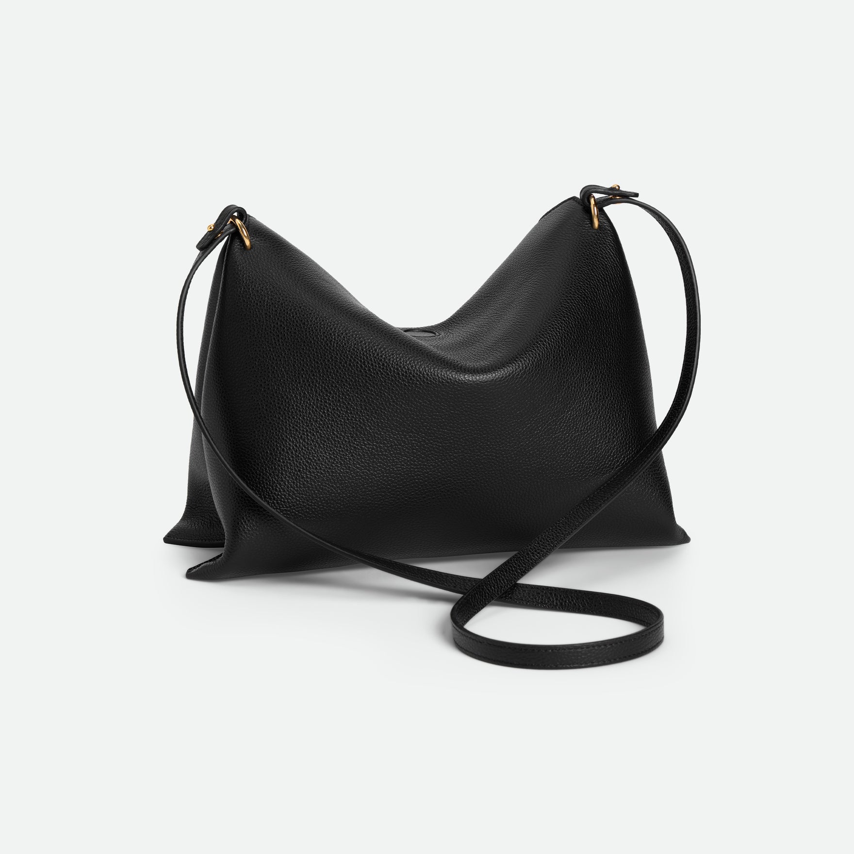Wandler Penelope Tote Small in the color Black Crust made from calf leather with golden hardware and soft slouchy silhouette, backside view.