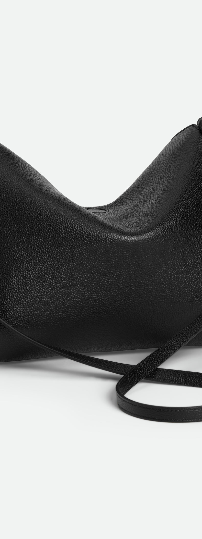 Wandler Penelope Tote Small in the color Black Crust made from calf leather with golden hardware and soft slouchy silhouette, backside view.