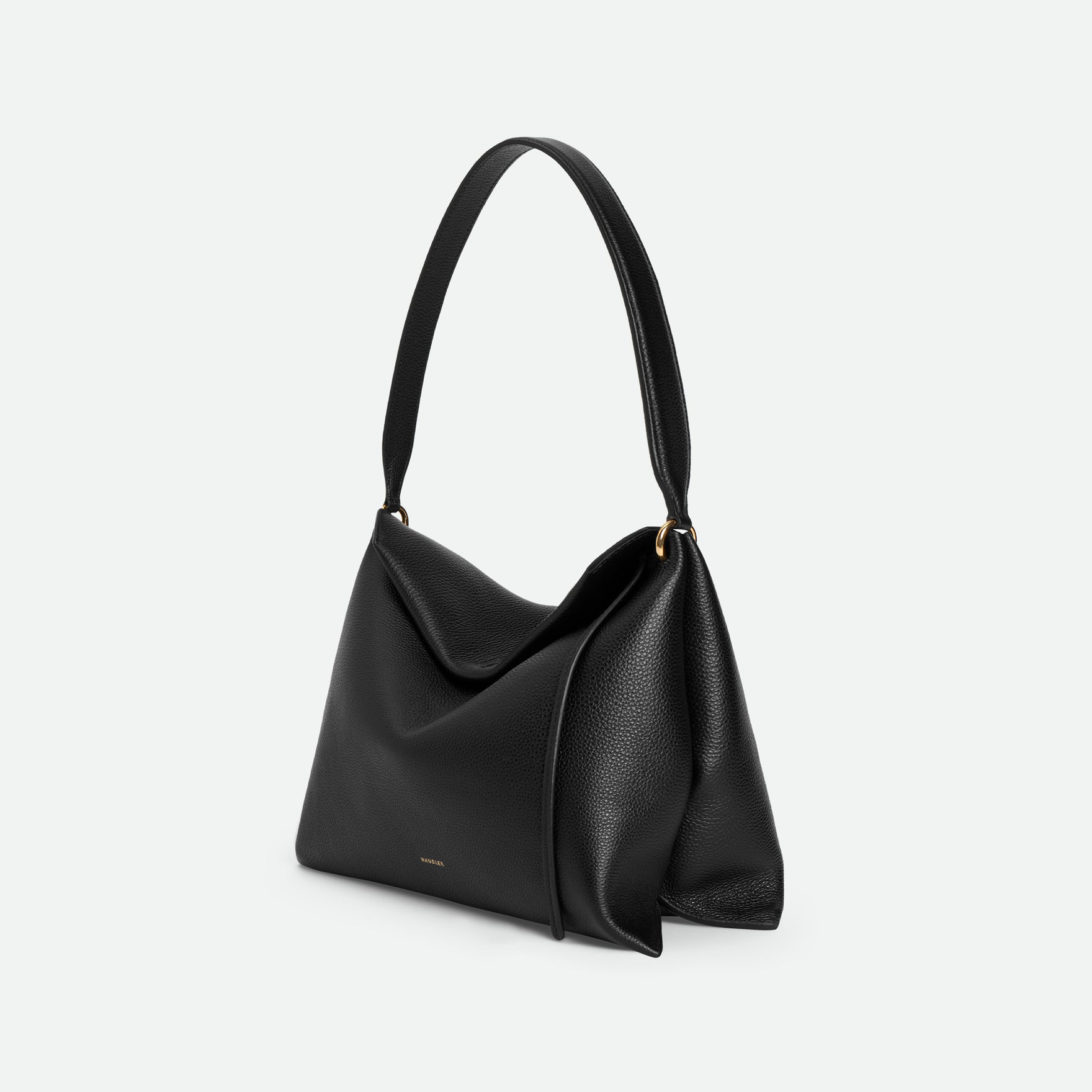 Wandler Penelope Tote Small in the color Black Crust made from calf leather with golden hardware and soft slouchy silhouette, side view.