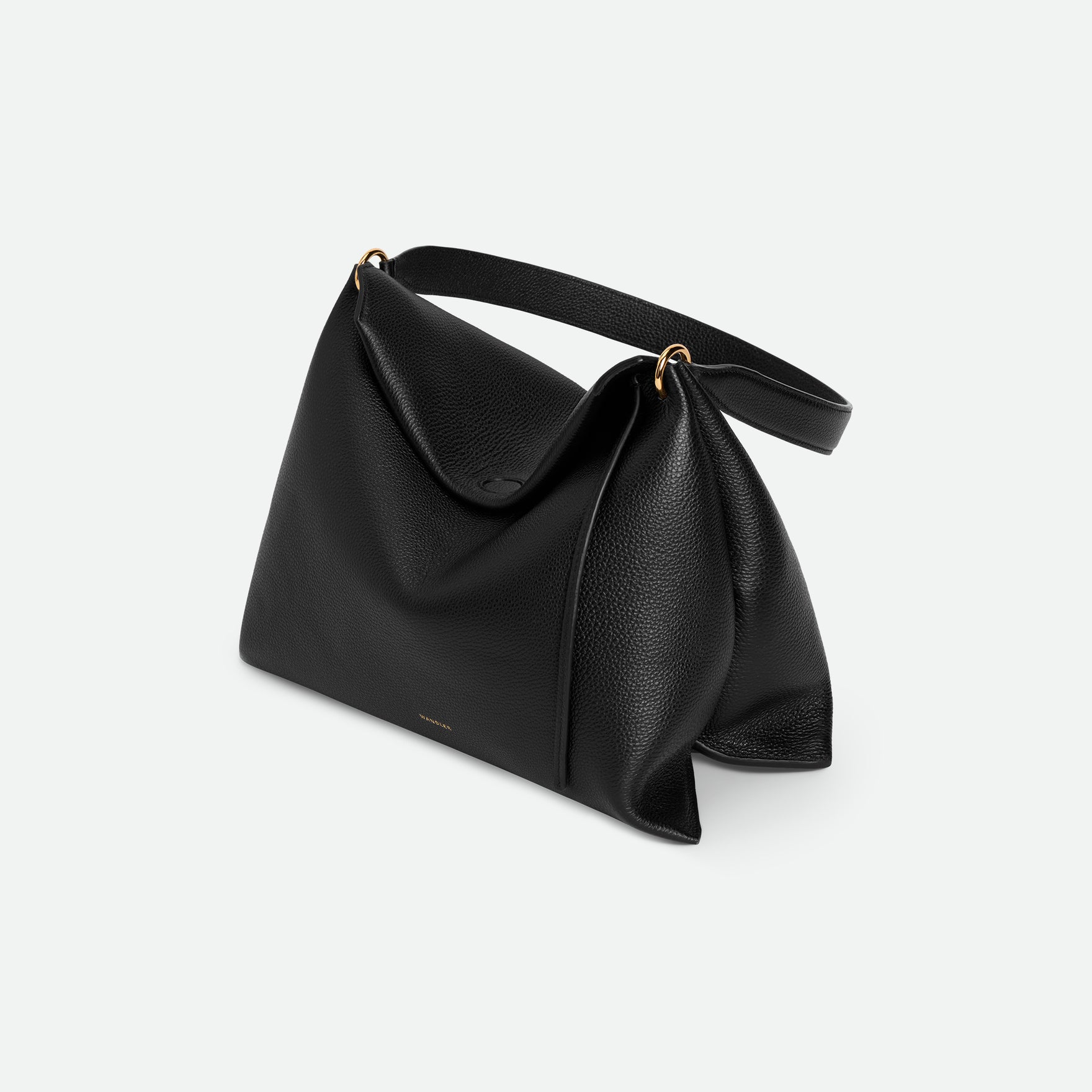Wandler Penelope Tote Small in the color Black Crust made from calf leather with golden hardware and soft slouchy silhouette, pictured from above, three quarters view.