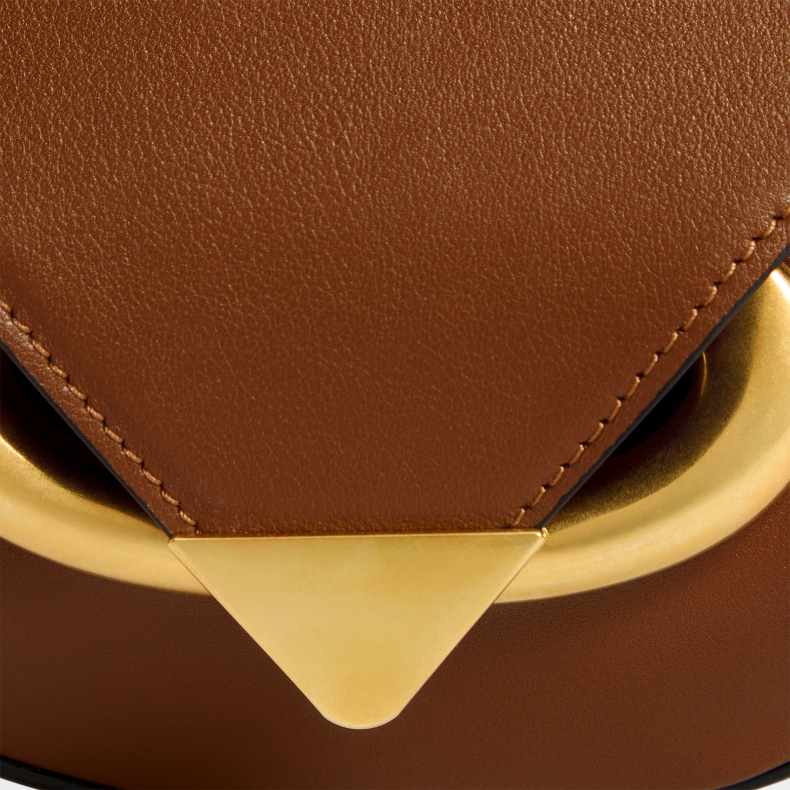 Wandler Veneto Crossbody Small in Saddle, warm brown, made from Italian calf leather with golden clasp hardware and structured silhouette, close up detailing the clasp and leather. 