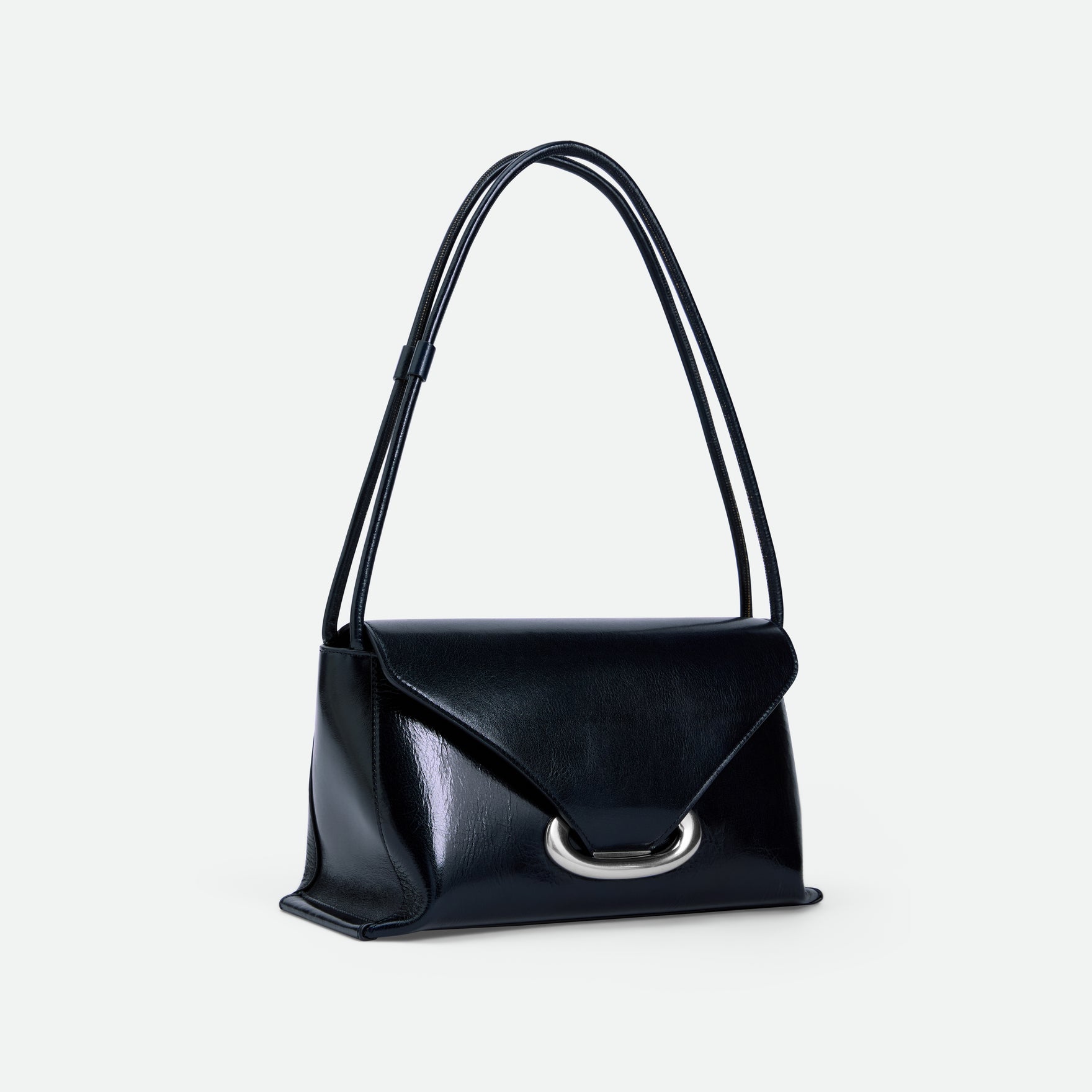 Wandler Veneto Shoulder Bag in the color Orion Glaze, deep dark blue, Italian calf leather with oversized silver clasp hardware and structured silhouette, pictured at a three quarters angle with the straps suspended into the air. 