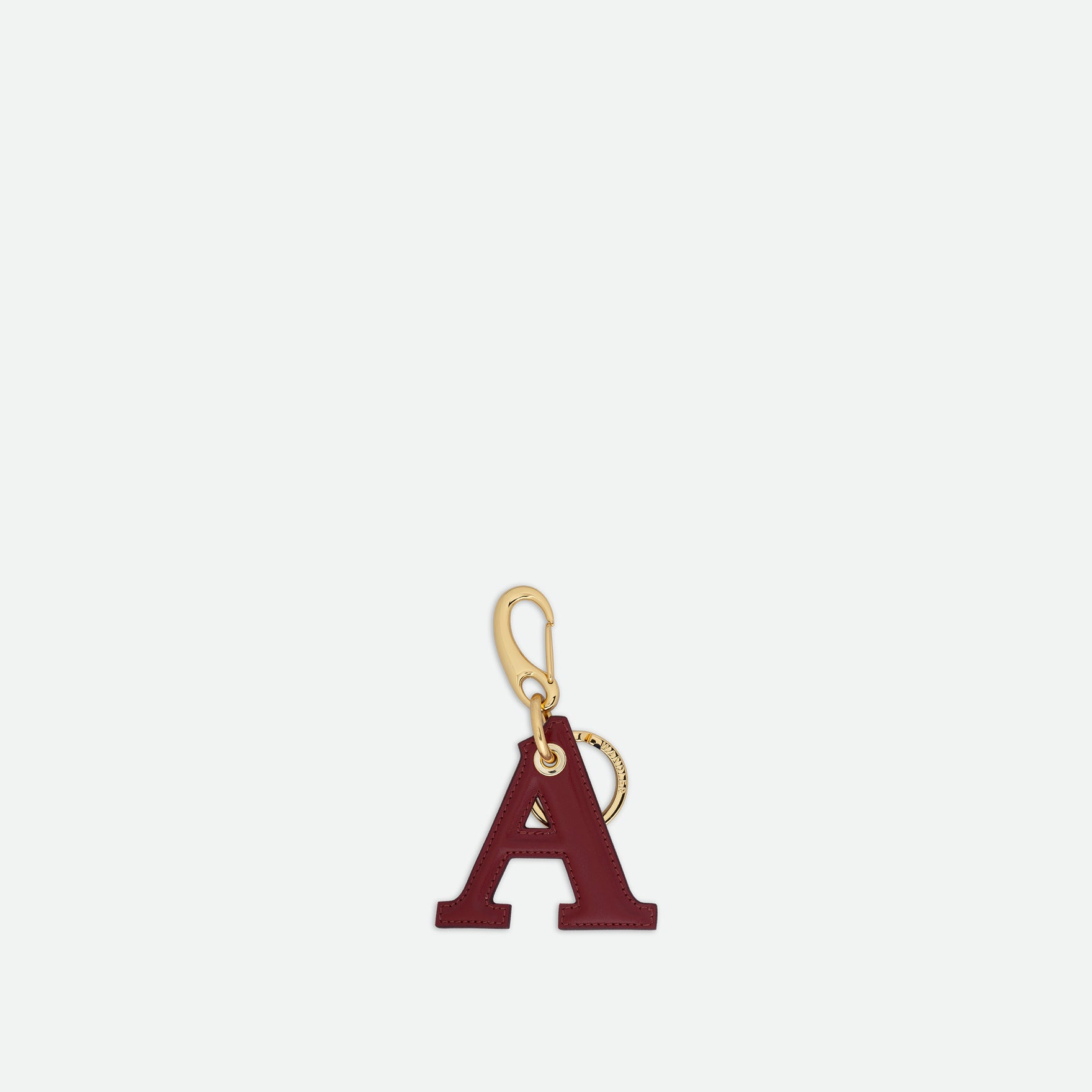Wandler Bag Charm Letter in the color Mahogamy, red, Letter A, made from brass, lambskin leather with golden hardware, front view.