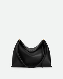 Wandler Penelope Tote Small in the color Black Crust made from calf leather with golden hardware and soft slouchy silhouette, front view.