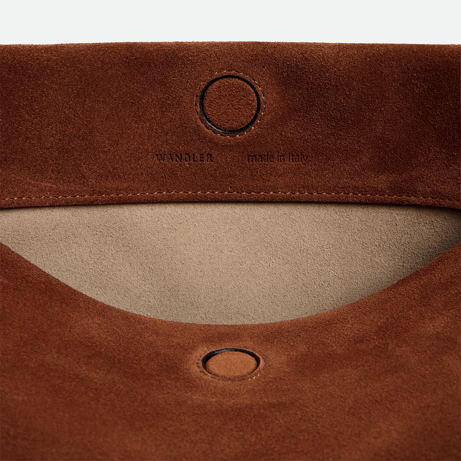 Wandler Penelope Tote Small in the color Saddle Suede calf leather with golden hardware and soft slouchy silhouette, close up picture detailing the logo and the leather.
