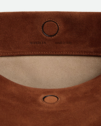 Wandler Penelope Tote Small in the color Saddle Suede calf leather with golden hardware and soft slouchy silhouette, close up picture detailing the logo and the leather.