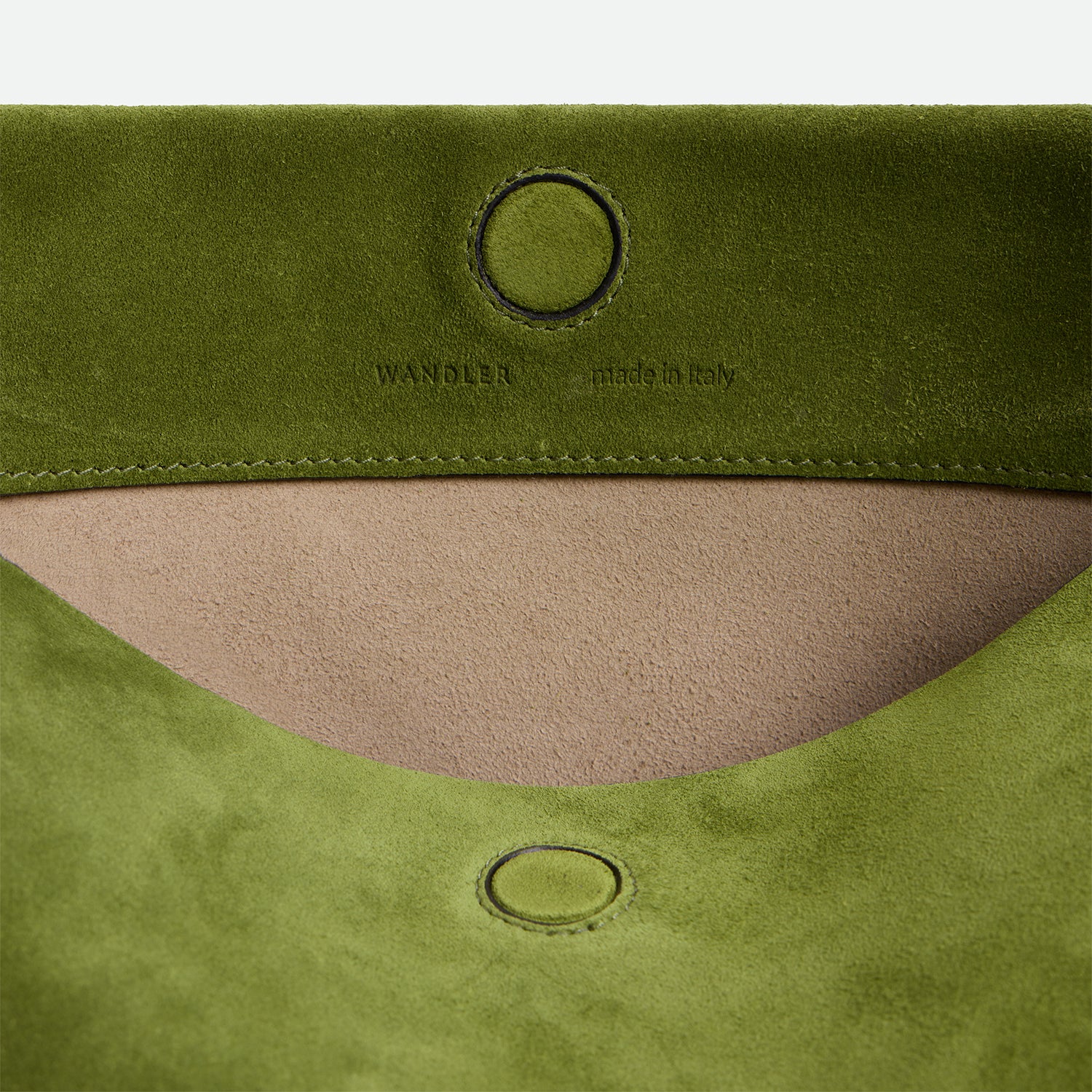 Wandler Penelope Tote Small in the color Verde Suede / Black made from calf leather with golden hardware and soft slouchy silhouette, close up detailing the closure and leather.
