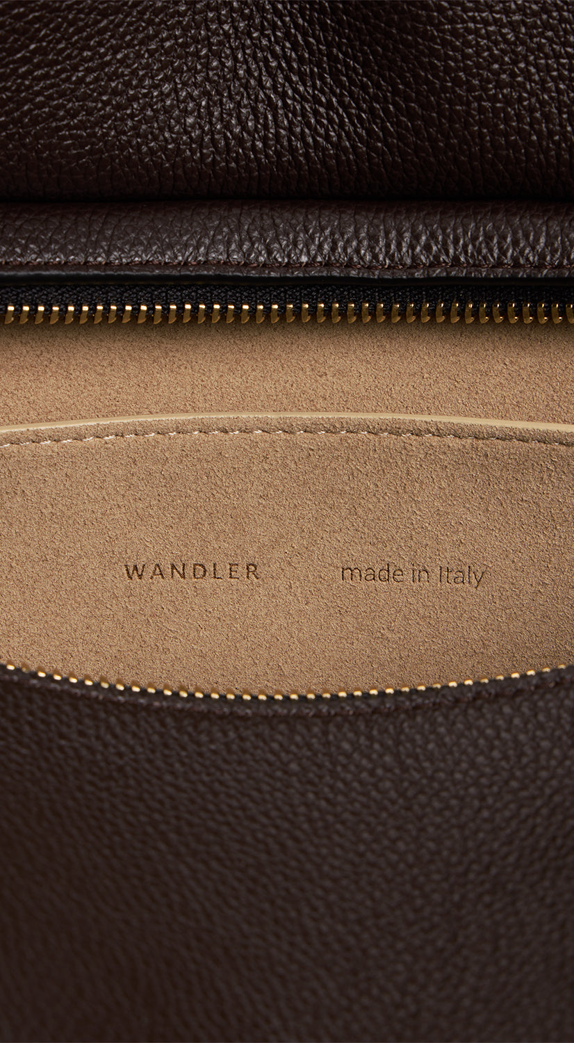 Wandler Penelope Tote in the color Soil Crust, made from Italian calf leather with golden hardware and soft structured silhouette, close up detailing the interior leather and logo.