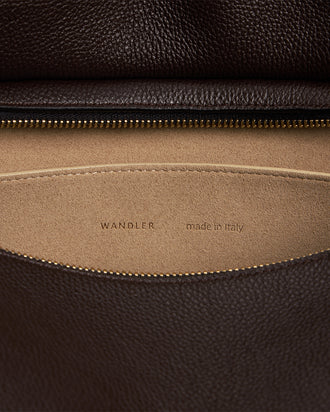 Wandler Penelope Tote in the color Soil Crust, made from Italian calf leather with golden hardware and soft structured silhouette, close up detailing the interior leather and logo.