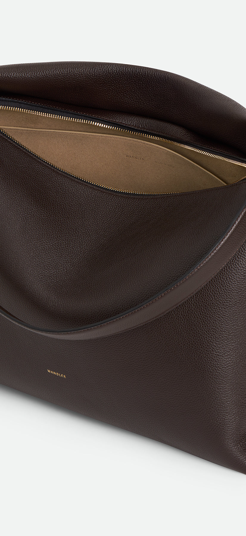 Wandler Penelope Tote in the color Soil Crust, made from Italian calf leather with golden hardware and soft structured silhouette, pictured from above with zipper open, giving a glimpse of the inside of the bag.
