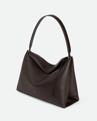Wandler Penelope Tote in the color Soil Crust, made from Italian calf leather with golden hardware and soft structured silhouette, three quarters view.