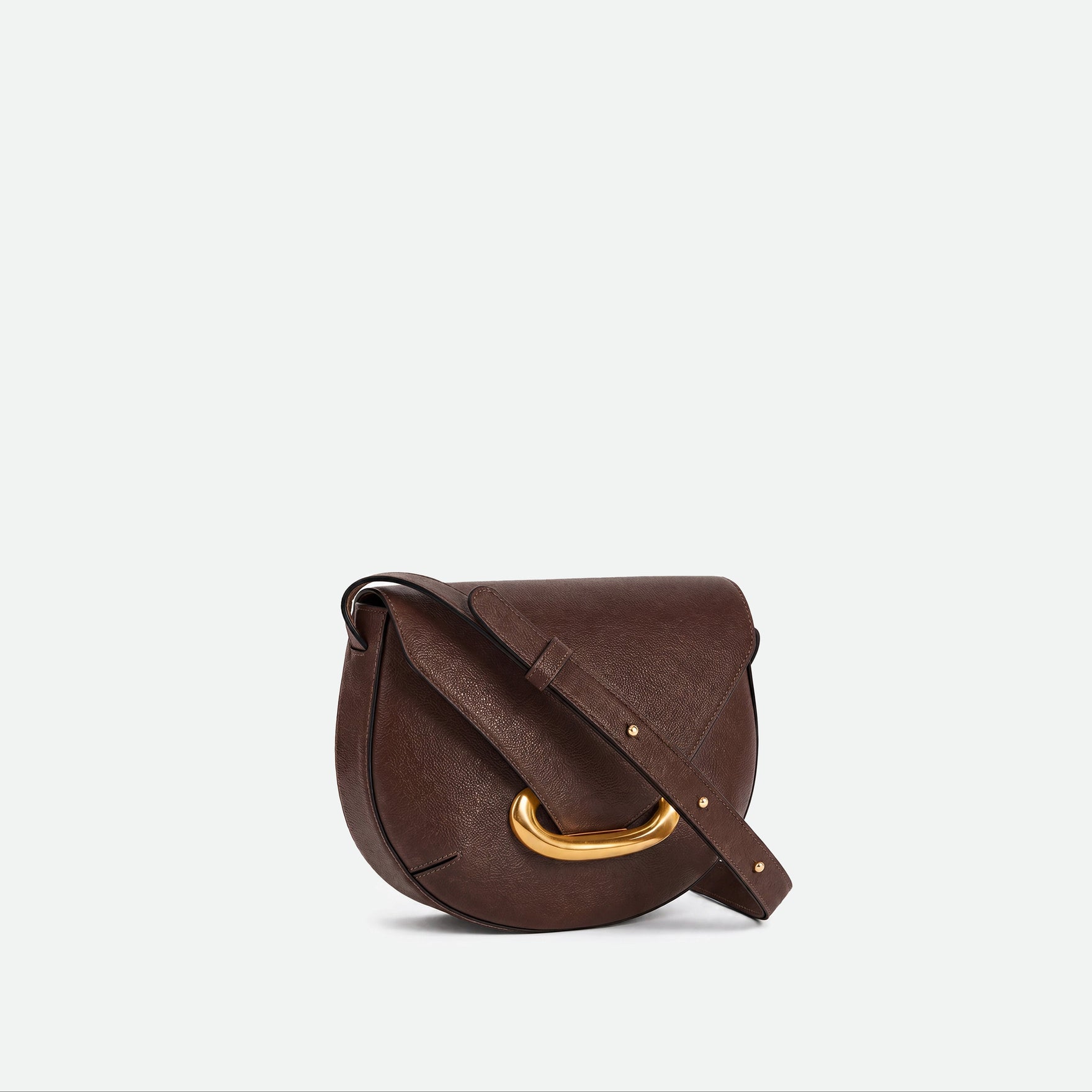 Wandler Veneto Crossbody Bag in Soil Caviar calf leather with oversized golden clasp hardware and structured silhouette, three quarters view. 