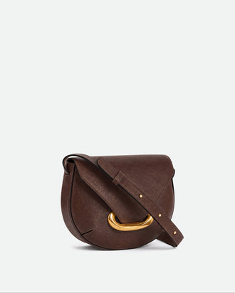 Wandler Veneto Crossbody Bag in Soil Caviar calf leather with oversized golden clasp hardware and structured silhouette, three quarters view. 