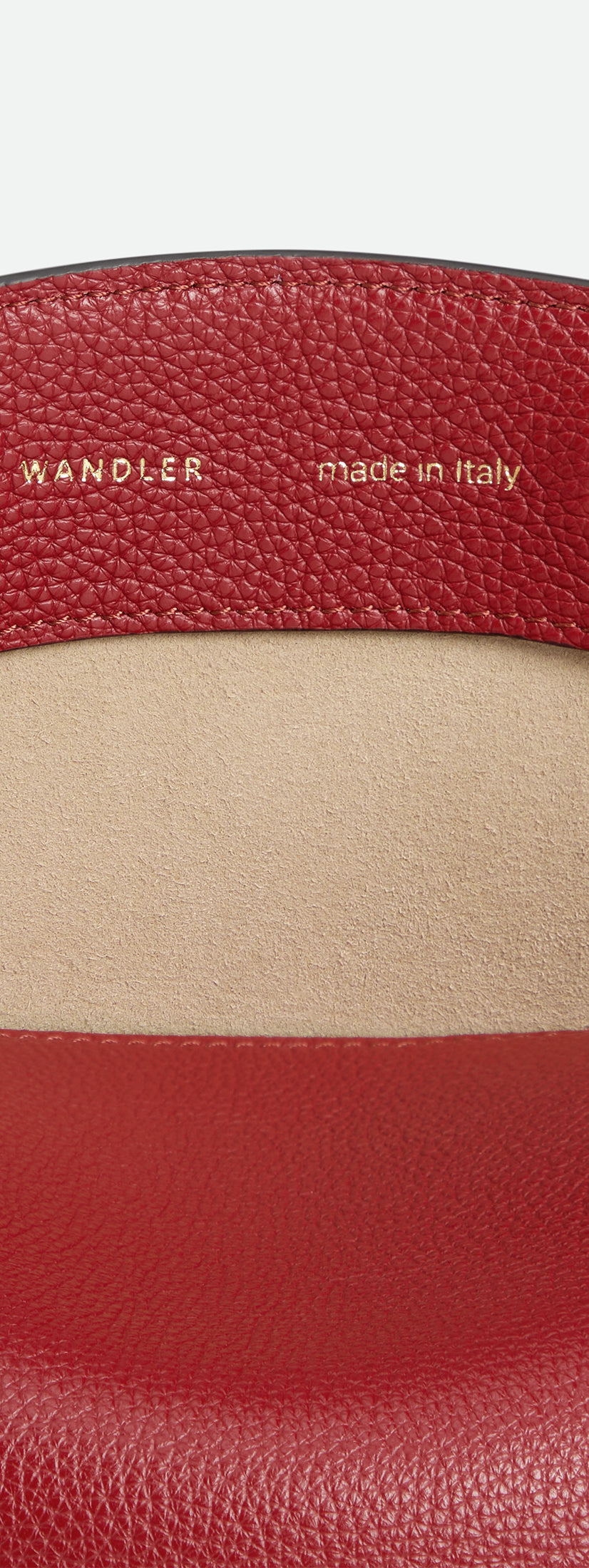 Wandler Penelope Slouch Bag in the color Scarlet Crust, made from calf leather with golden hardware and adjustable slim strap, close up detailing the closure and leather.
