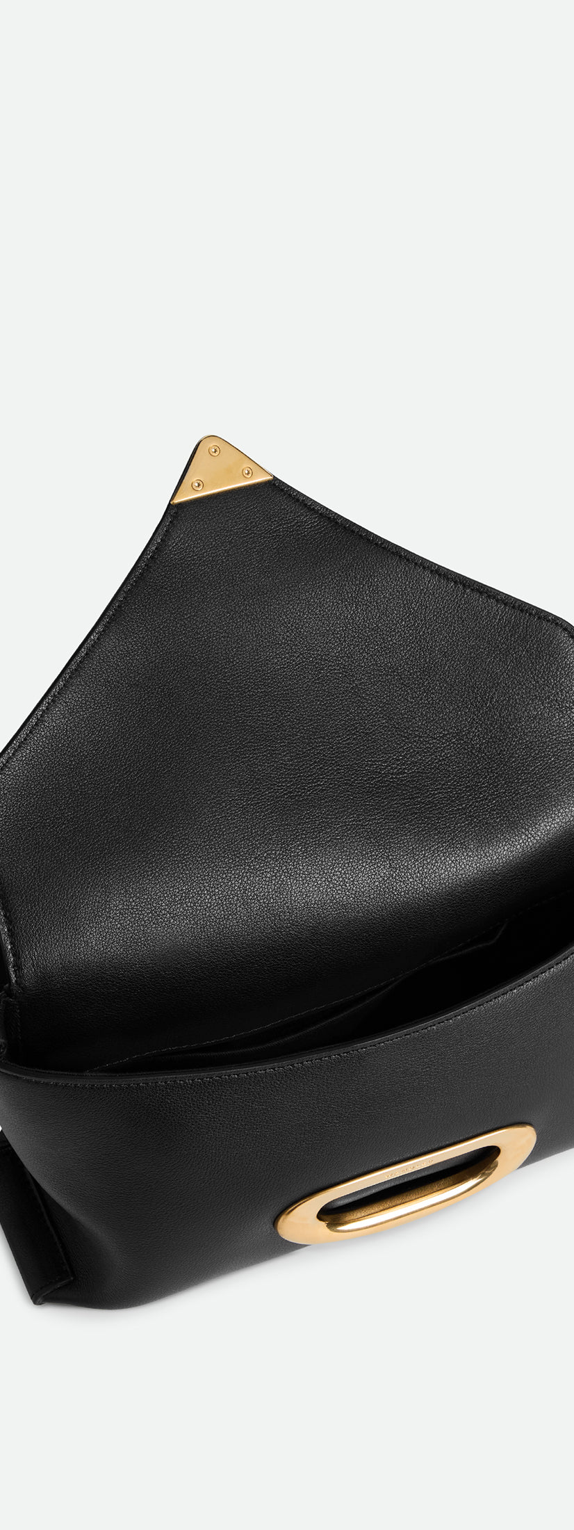 Wandler Veneto Shoulder Bag Small in the color Island, made from Italian calf leather with oversized golden clasp hardware, structured silhouette, pictured from above with the flap open, giving a glimpse into the inside of the bag.
