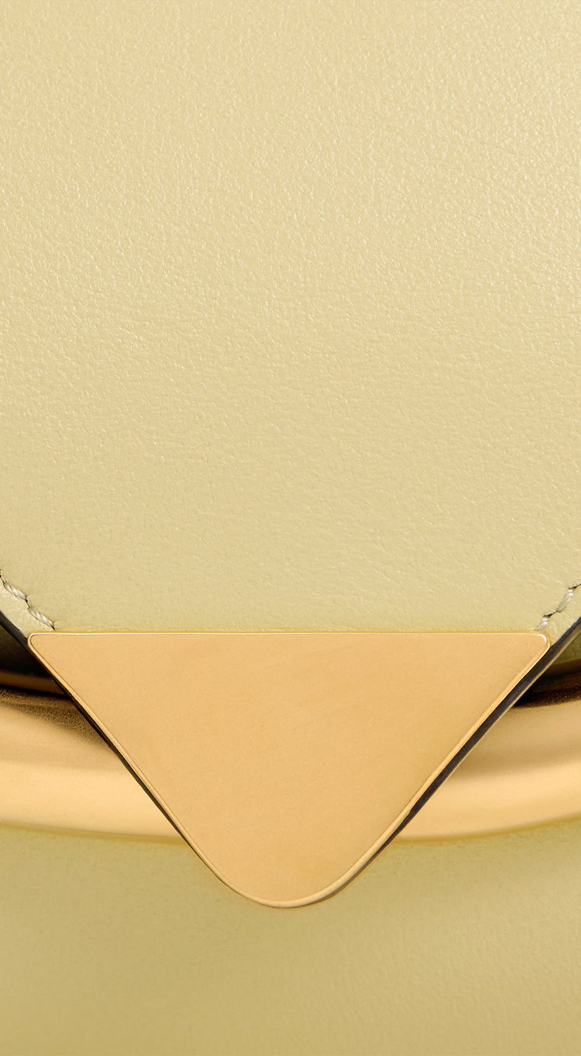 Wandler Veneto Shoulder Bag Small in the color Island, made from Italian calf leather with oversized golden clasp hardware, structured silhouette, close up detailing the clasp and the leather.