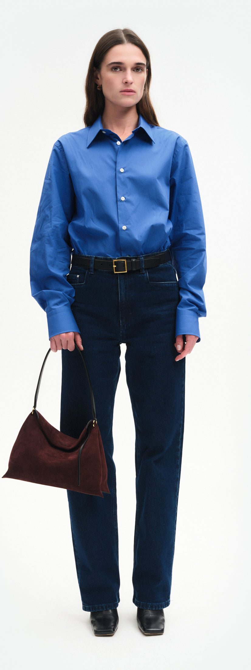 Wandler Penelope Tote Small in the color Acai Suede / Black made from calf leather with golden hardware and soft slouchy silhouette, pictured being handheld by model, full body picture.
