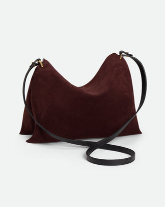 Wandler Penelope Tote Small in the color Acai Suede / Black made from calf leather with golden hardware and soft slouchy silhouette, backside view.