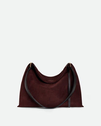 Wandler Penelope Tote Small in the color Acai Suede / Black made from calf leather with golden hardware and soft slouchy silhouette, front view.