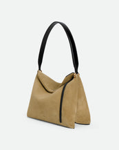 Wandler Penelope Tote Small in the color Acai Suede / Black made from calf leather with golden hardware and soft slouchy silhouette, three quarters view.