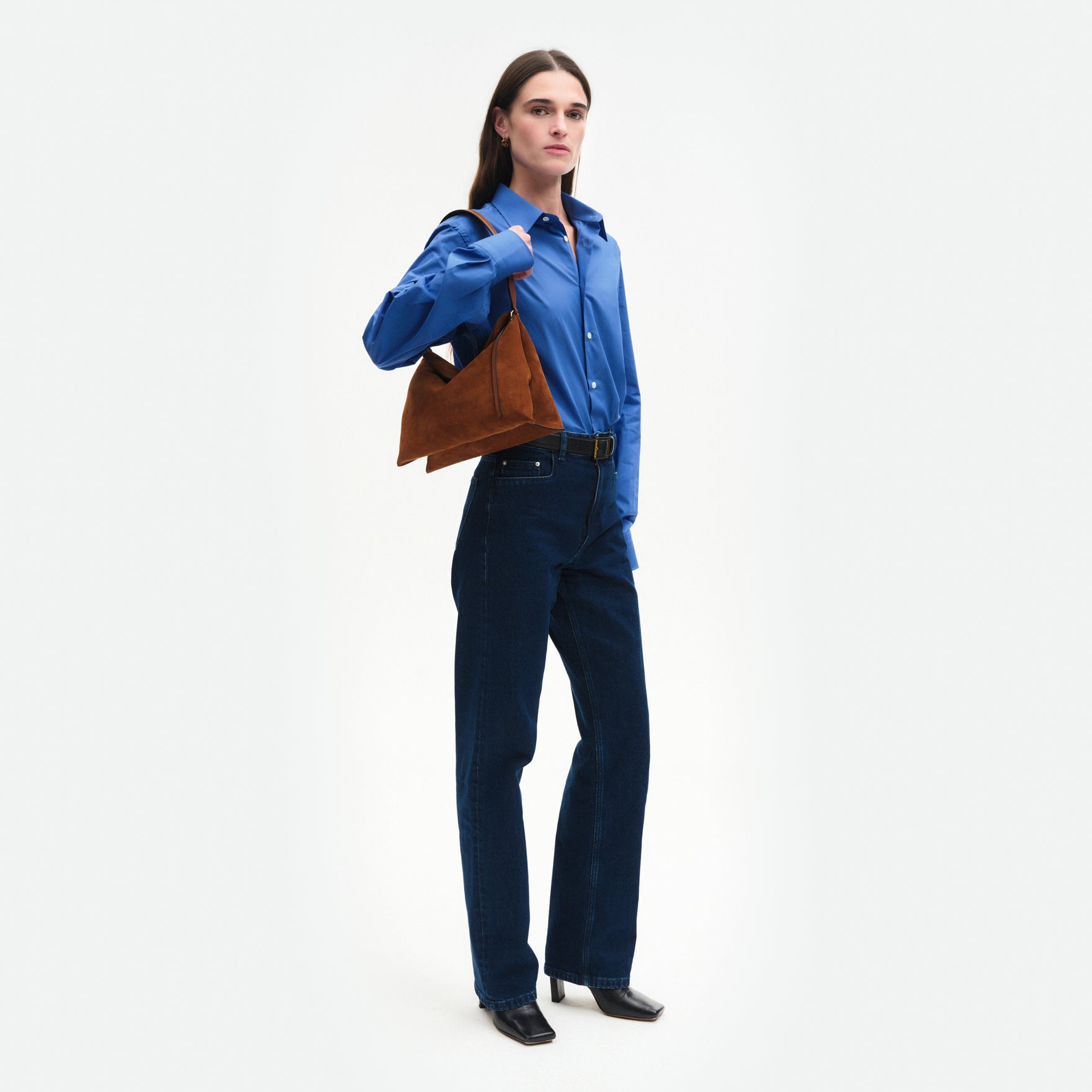 Wandler Penelope Tote Small in the color Saddle Suede calf leather with golden hardware and soft slouchy silhouette, pictured on model, worn on the shoulder full body picture.