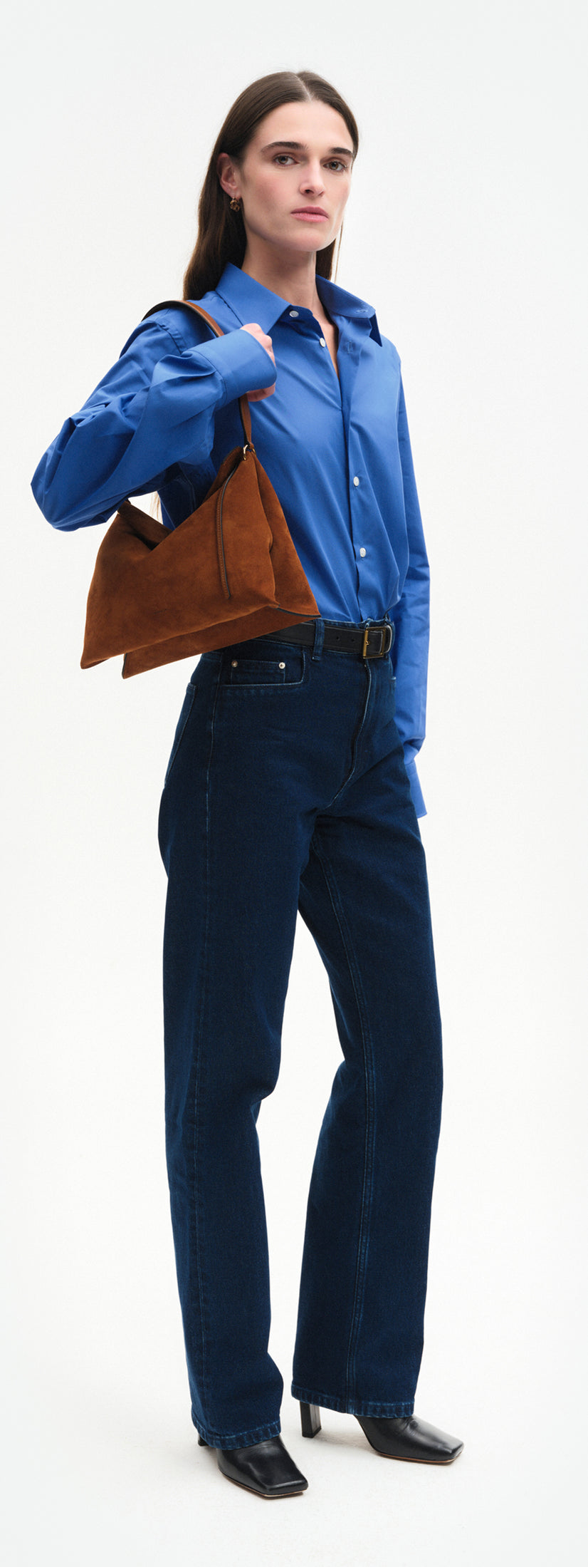 Wandler Penelope Tote Small in the color Saddle Suede calf leather with golden hardware and soft slouchy silhouette, pictured on model, worn on the shoulder full body picture.