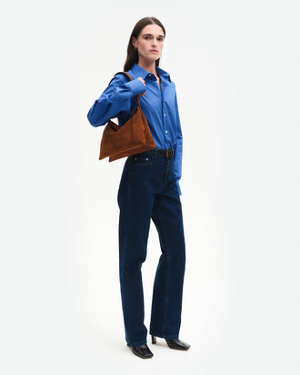 Wandler Penelope Tote Small in the color Saddle Suede calf leather with golden hardware and soft slouchy silhouette, pictured on model, worn on the shoulder full body picture.