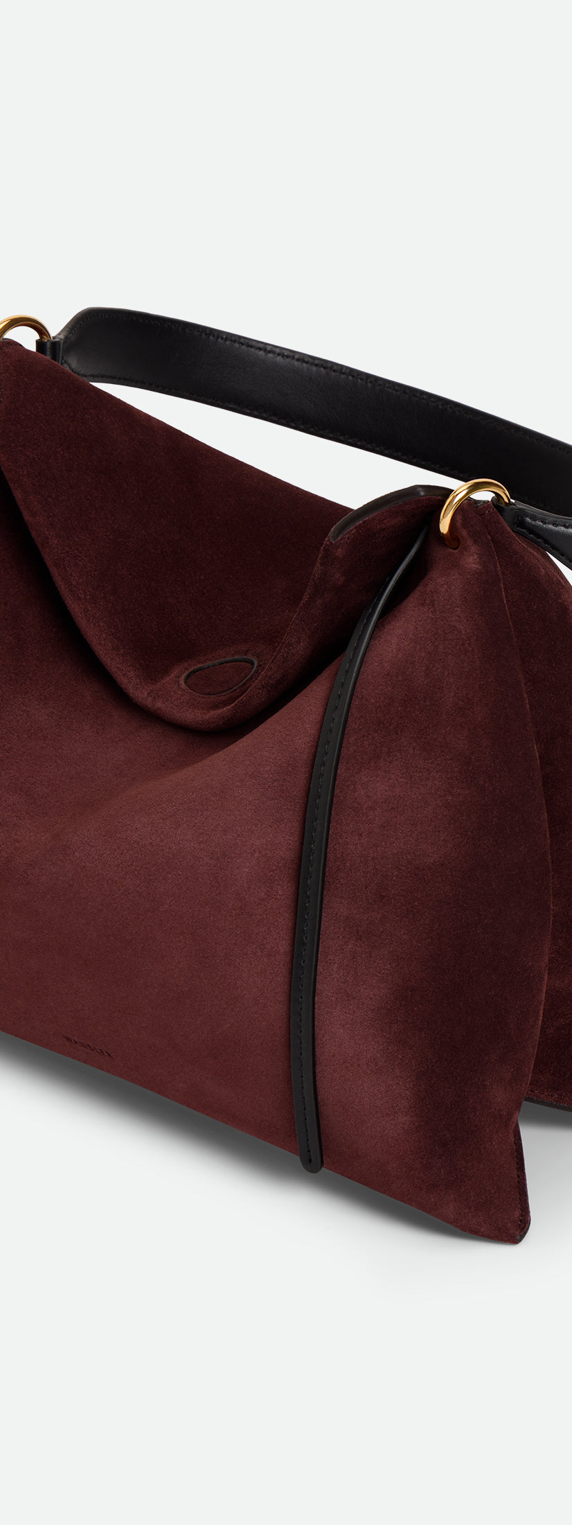 Wandler Penelope Tote Small in the color Acai Suede / Black made from calf leather with golden hardware and soft slouchy silhouette, three quarters view.