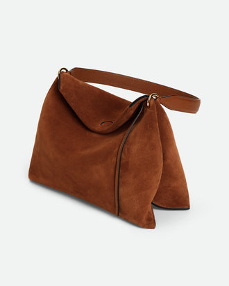 Wandler Penelope Tote Small in the color Saddle Suede calf leather with golden hardware and soft slouchy silhouette, threequarters view.