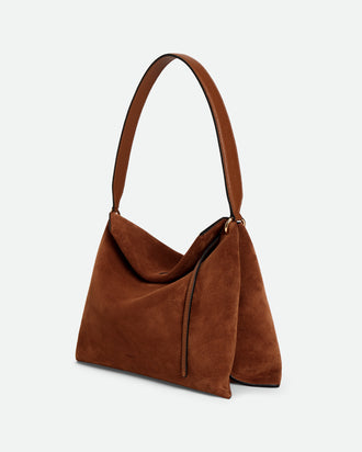 Wandler Penelope Tote Small in the color Saddle Suede calf leather with golden hardware and soft slouchy silhouette, three quarters view.