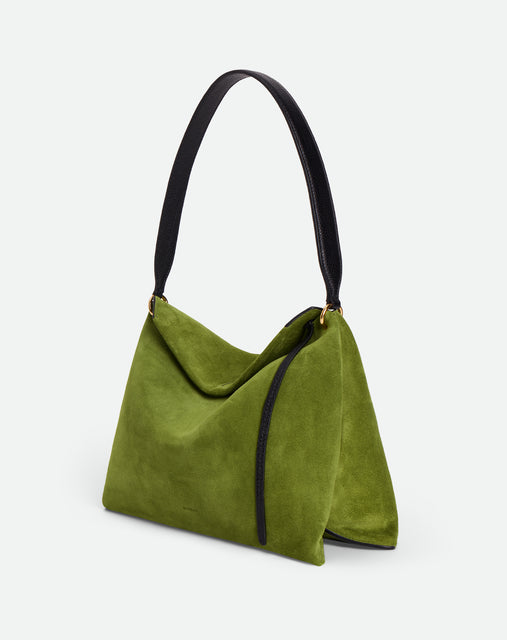 Wandler Penelope Tote Small in the color Verde Suede / Black made from calf leather with golden hardware and soft slouchy silhouette, three quarters view.