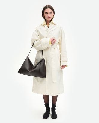 Wandler Penelope Tote in the color Soil Crust, made from Italian calf leather with golden hardware and soft structured silhouette, pictured being worn on the fore arm by model.