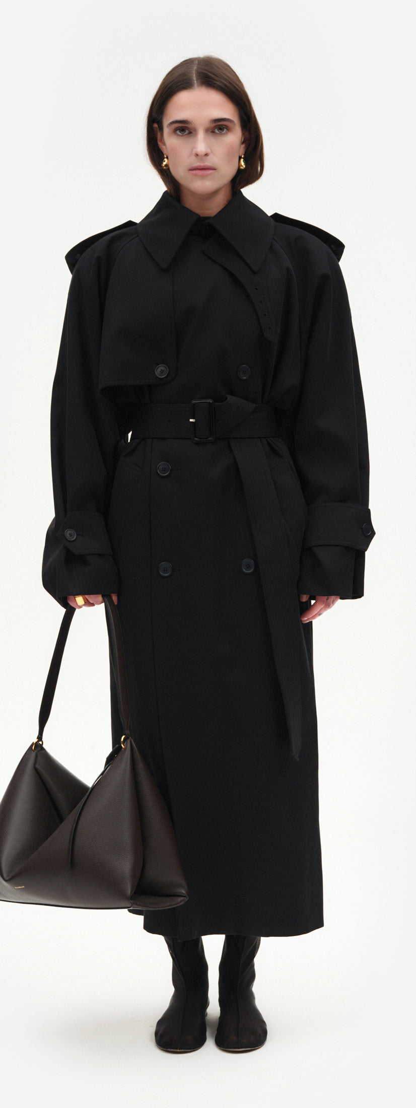 Wandler Penelope Tote in the color Soil Crust, made from Italian calf leather with golden hardware and soft structured silhouette, pictured being hand-held by model.