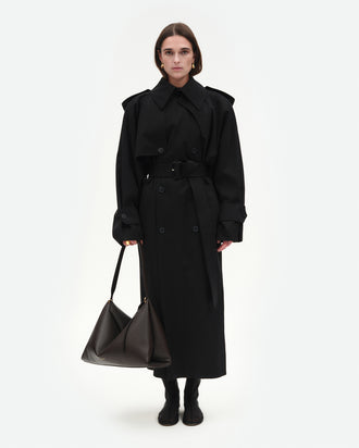 Wandler Penelope Tote in the color Soil Crust, made from Italian calf leather with golden hardware and soft structured silhouette, pictured being hand-held by model.