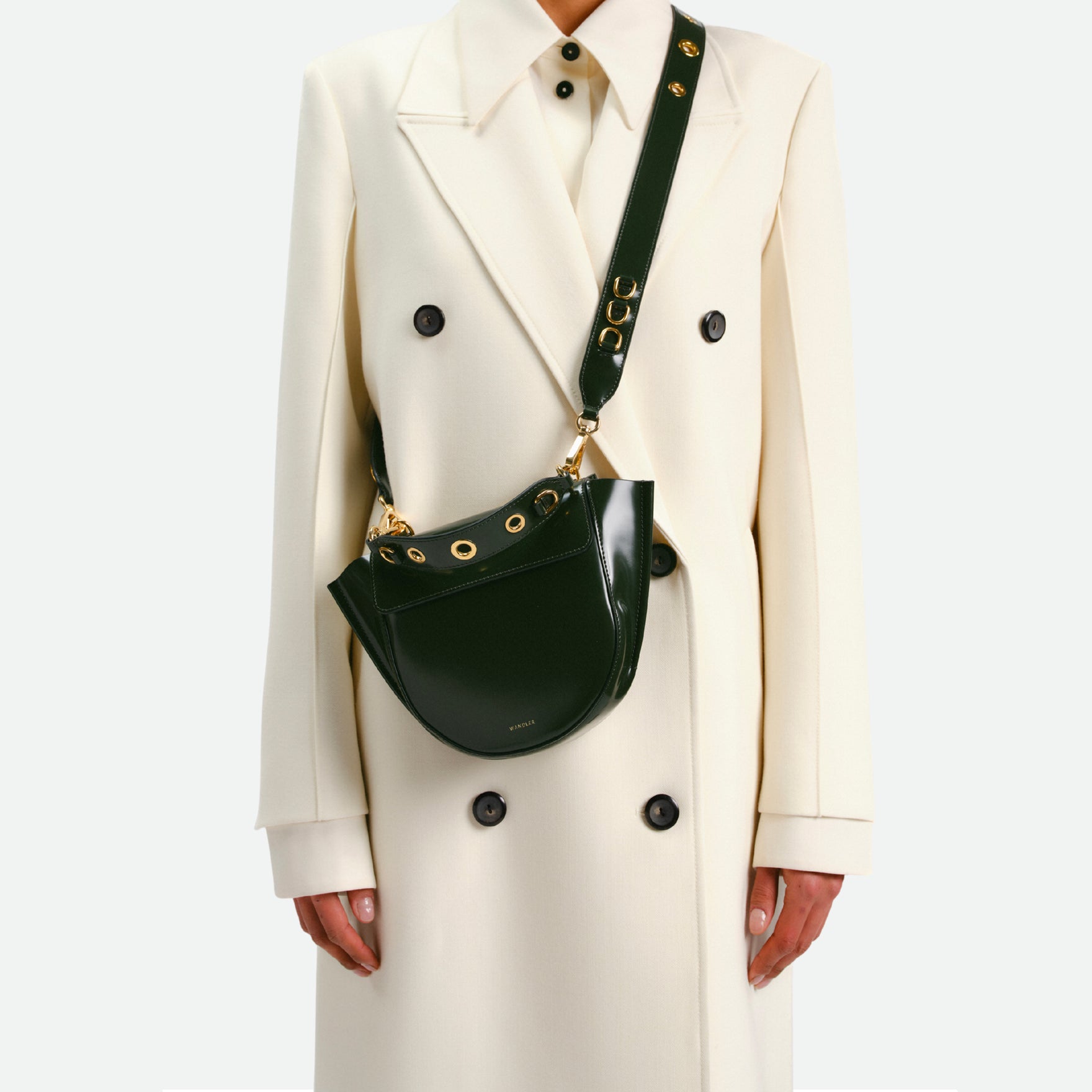 Wandler Hortensia Bag Mini Eyelets in the color Jazz Olive, made from Italian calf leather with golden hardware and rounded silhouette, pictured being worn on the shoulder by model.
