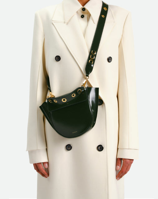 Wandler Hortensia Bag Mini Eyelets in the color Jazz Olive, made from Italian calf leather with golden hardware and rounded silhouette, pictured being worn on the shoulder by model.