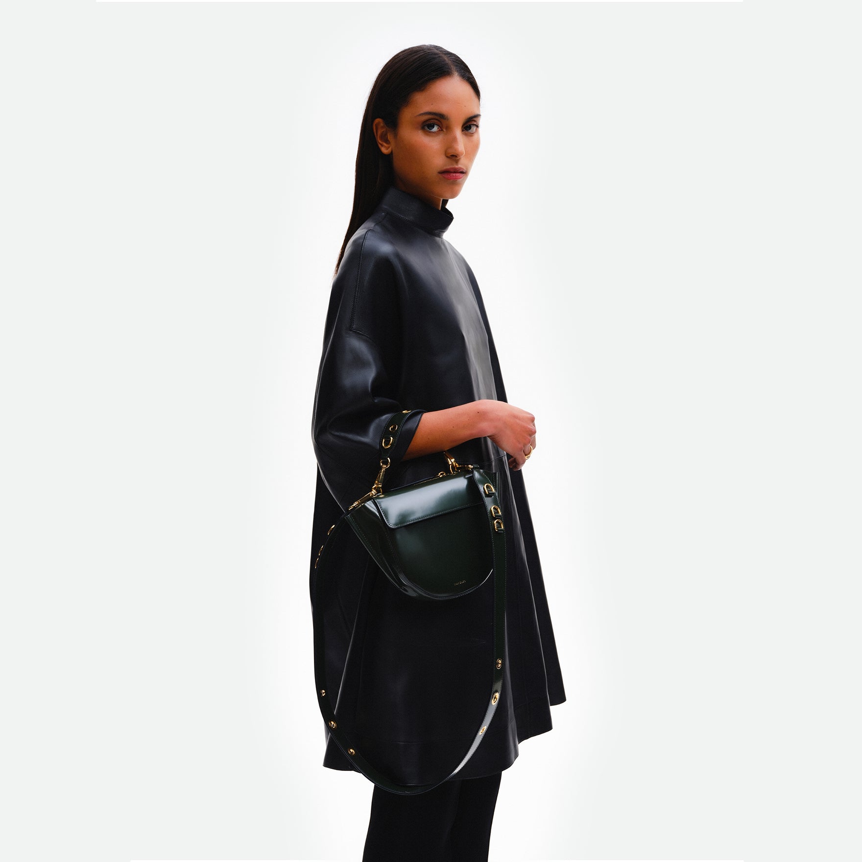 Wandler Hortensia Bag Mini Eyelets in the color Jazz Olive, made from Italian calf leather with golden hardware and rounded silhouette, pictured being worn on the forearm by model.