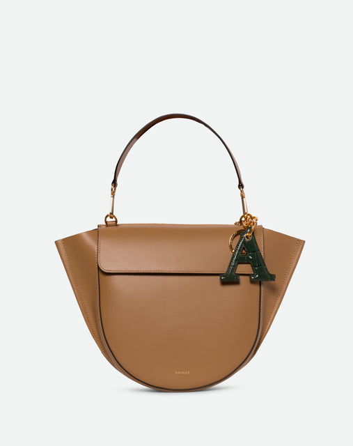 Wandler Bag Charm Letter in the color Olive Croco, green with crocodile print, Letter M, made from brass, lambskin leather with golden hardware, pictured being used as a bag charm on Hortensia Bag.