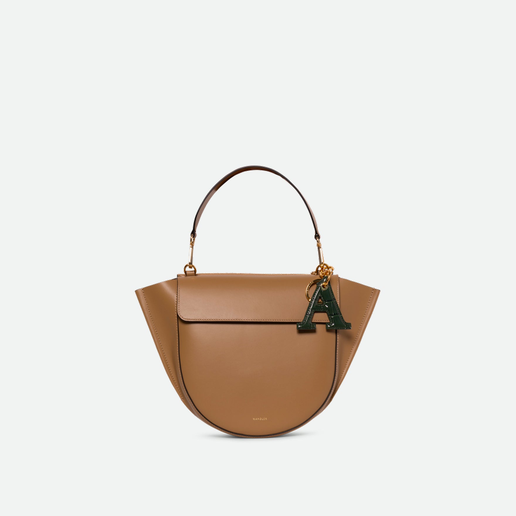 Wandler Bag Charm Letter in the color Olive Croco, green with crocodile print, Letter M, made from brass, lambskin leather with golden hardware, pictured being used a bag charm.