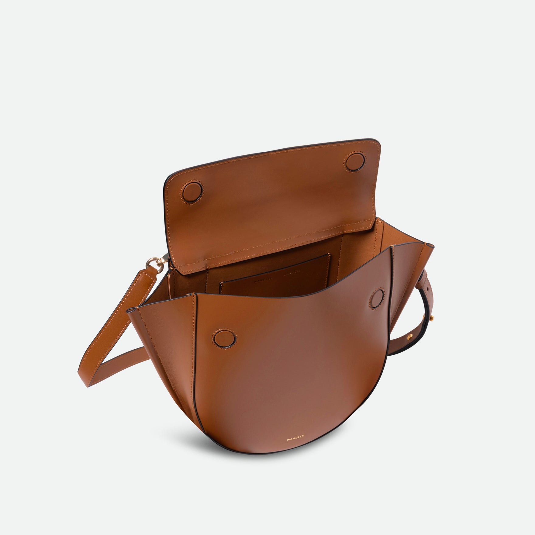 Wandler Hortensia Bag Medium in the color Saddle, warm brown, made from Italian calf leather with golden hardware, rounded silhouette and top handle, pictured from above with the flap open, giving a glimpse into the inside of the bag.