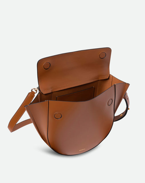 Wandler Hortensia Bag Medium in the color Saddle, warm brown, made from Italian calf leather with golden hardware, rounded silhouette and top handle, pictured from above with the flap open, giving a glimpse into the inside of the bag.