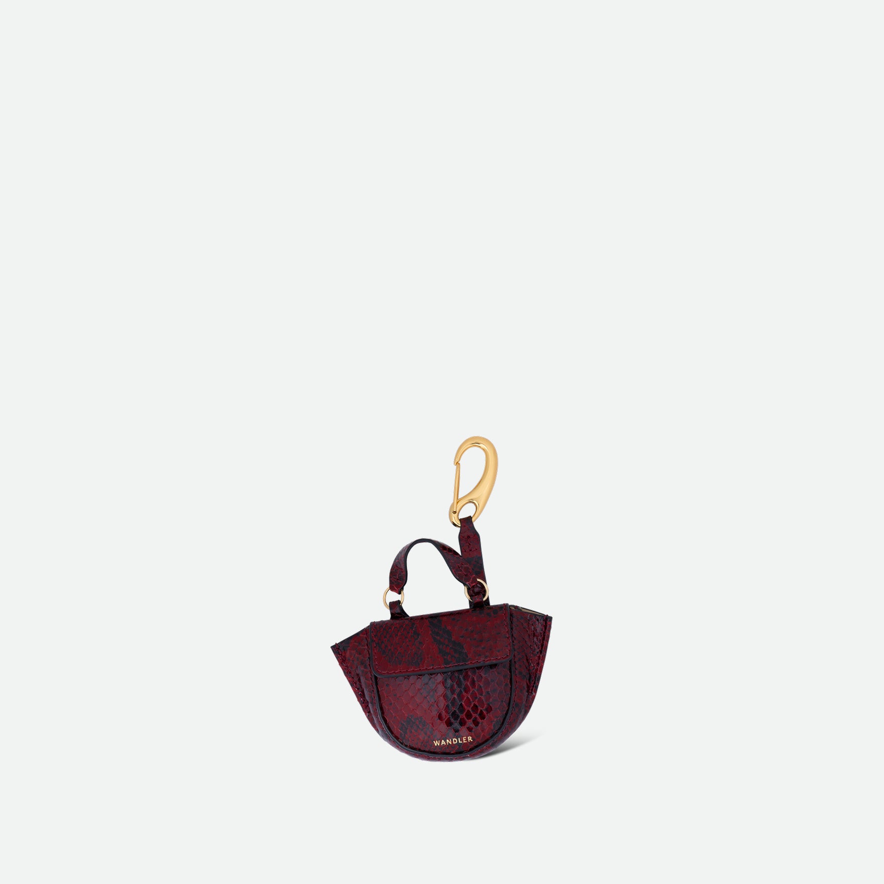 Wandler Hortensia Micro in the color Bordeaux Python, Bordeaux with snake print, leather with golden hardware, shown as a bag charm, front view.