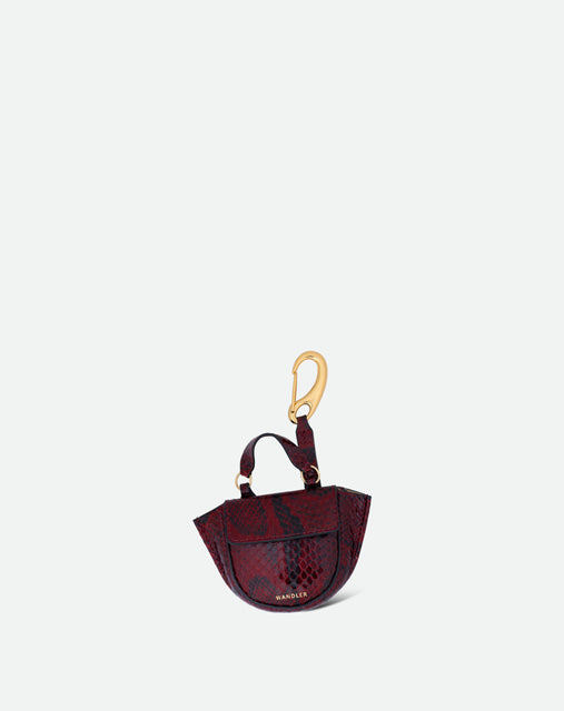 Wandler Hortensia Micro in the color Bordeaux Python, Bordeaux with snake print, leather with golden hardware, shown as a bag charm, front view.