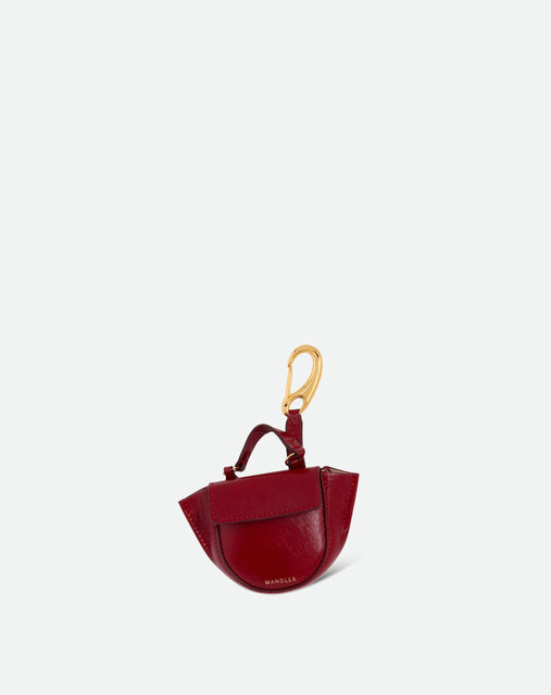 Wandler Hortensia Micro in cranberry calf leather with golden hardware, shown as a bag charm, front view.