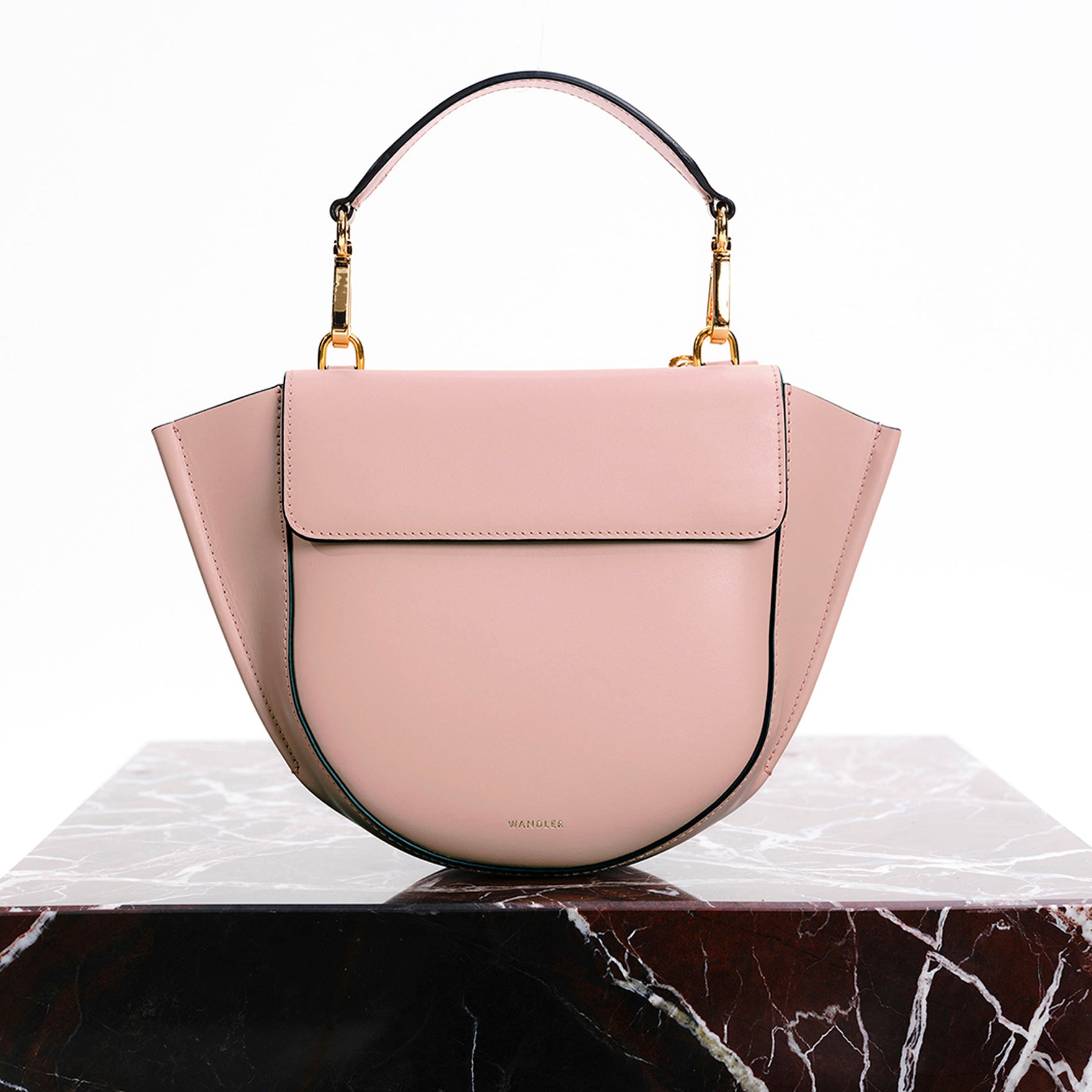 Wandler Hortensia Bag Mini in the color Apricot, light pink, Italian calf leather with golden hardware, rounded silhouette and top handle, front view, pictured on marble surface.