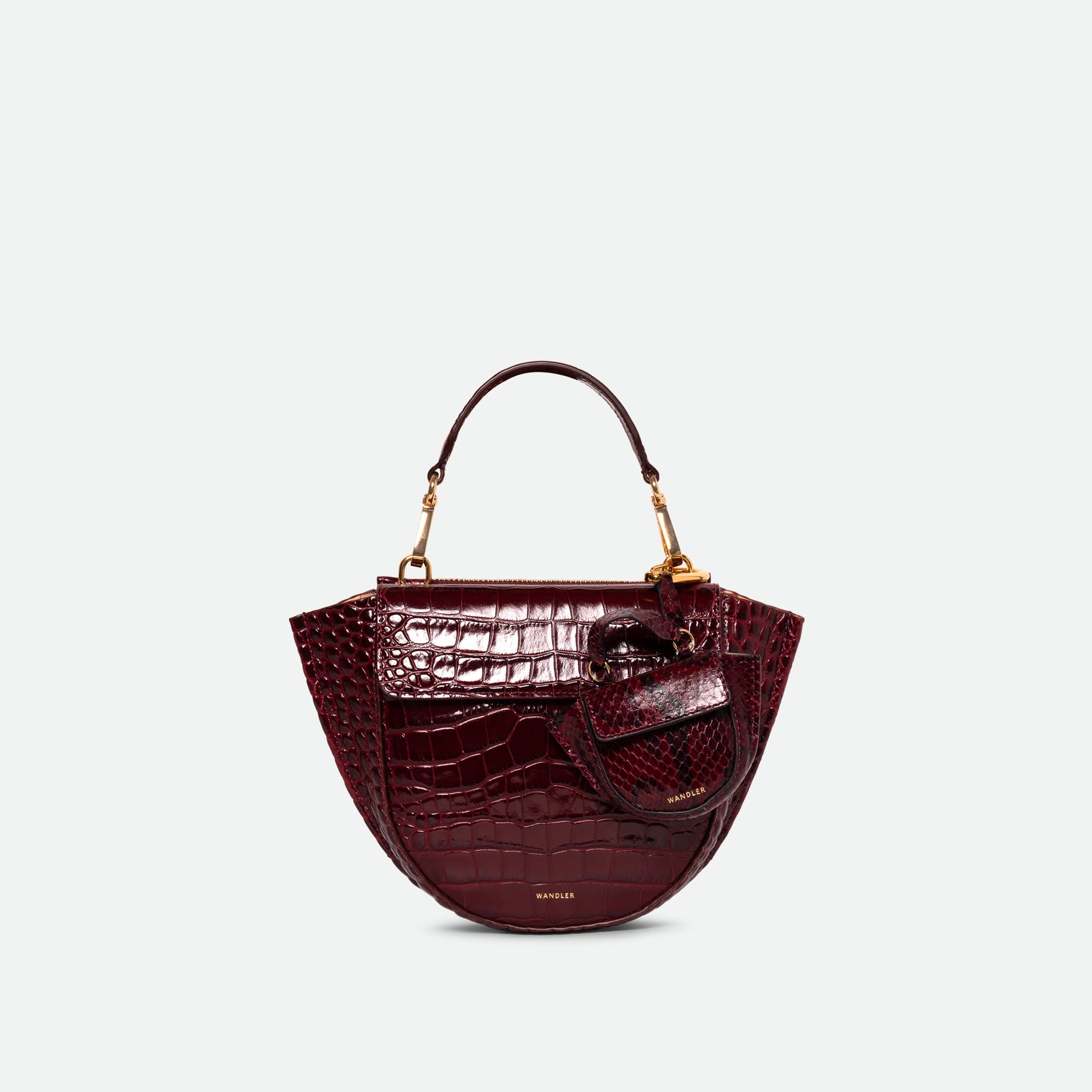 Wandler Hortensia Micro in the color Bordeaux Python, Bordeaux with snake print, leather with golden hardware, shown as a bag charm, attached as a bag charm onto a Hortensia Bag Mini.