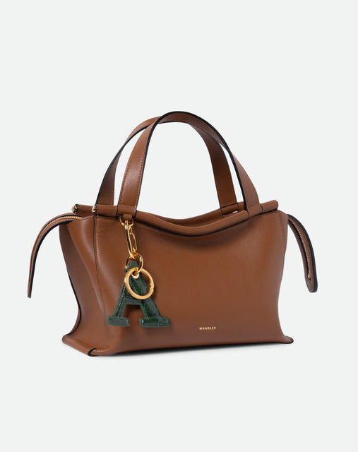 Wandler Bag Charm Letter in the color Olive Croco, green with crocodile print, Letter M, made from brass, lambskin leather with golden hardware, pictured being used as a bag charm on Ida Bag.